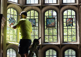 Crew installing new stained glass windows at Grace Hopper College, photo by Dan Renzetti