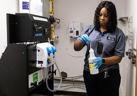 Facilities Operations worker prepares a green cleaning solution, photo by Hope Chang, courtesy of Yale Sustainability