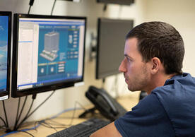 Facilities Operations staff member using service software, photo by Robert DeSanto