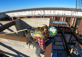An ironworker setting a steel beam at Kline Tower, photo by Ronnie Rysz