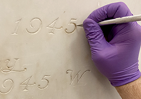 Conservation technician cleaning a marble panel, photo courtesy of Material Conservation Collaborative, Inc.