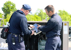 Refrigeration mechanic Lou Serenson (left) speaking with equipment mechanic Dan Benedetti (right), photo by Ronnie Rysz